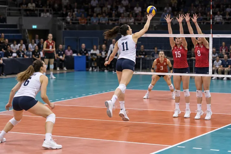 A player attacks over the net as defenders prepare in the front court.