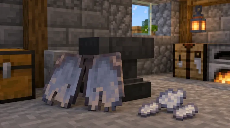 A worn Elytra and three phantom membranes sit beside an anvil in a stone workshop.