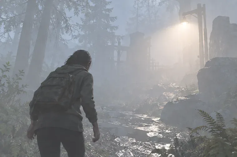 An overexposed foggy game scene with a bright lamp washing out the path and distant trees