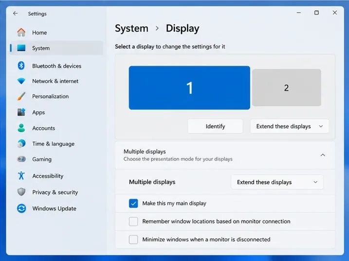 หน้าจอการตั้งค่าจอแสดงผลหลายจอของ Windows 11 ที่มีสี่เหลี่ยมสำหรับเลือกจอภาพสองจอและตัวเลือกจอแสดงผลหลัก