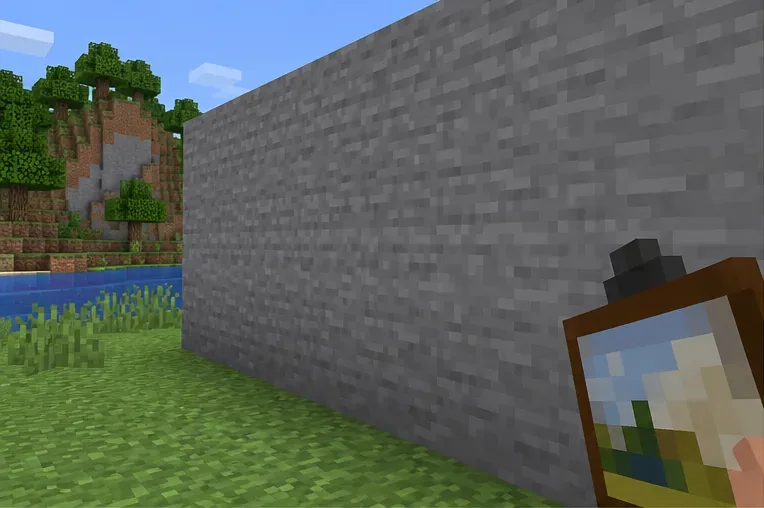 A painting held in front of a broad, flat stone wall in Minecraft.
