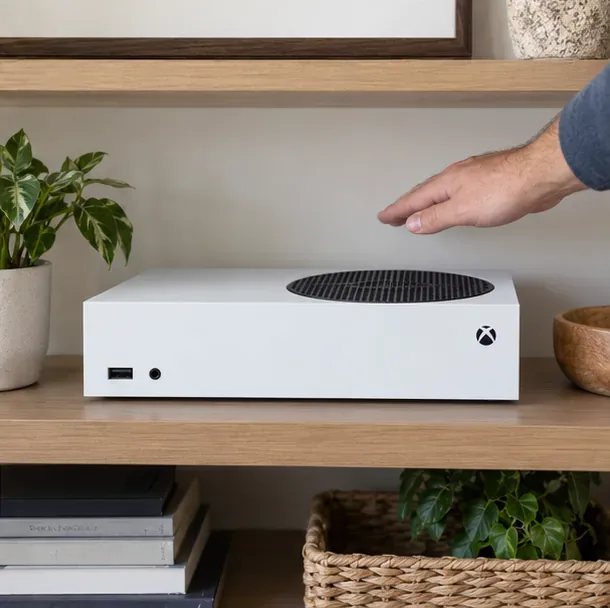 Xbox Series S resting horizontally on an open shelf with its circular exhaust vent clear and unobstructed