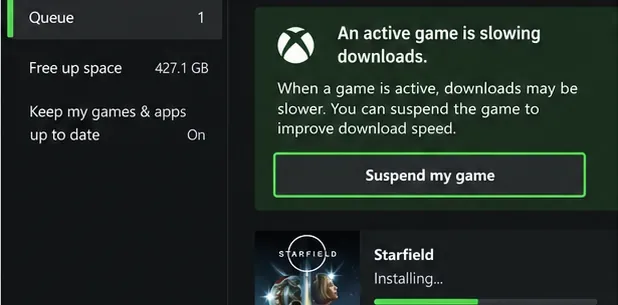 Illustrative Xbox queue notice that an active game is slowing downloads, with Suspend my game highlighted